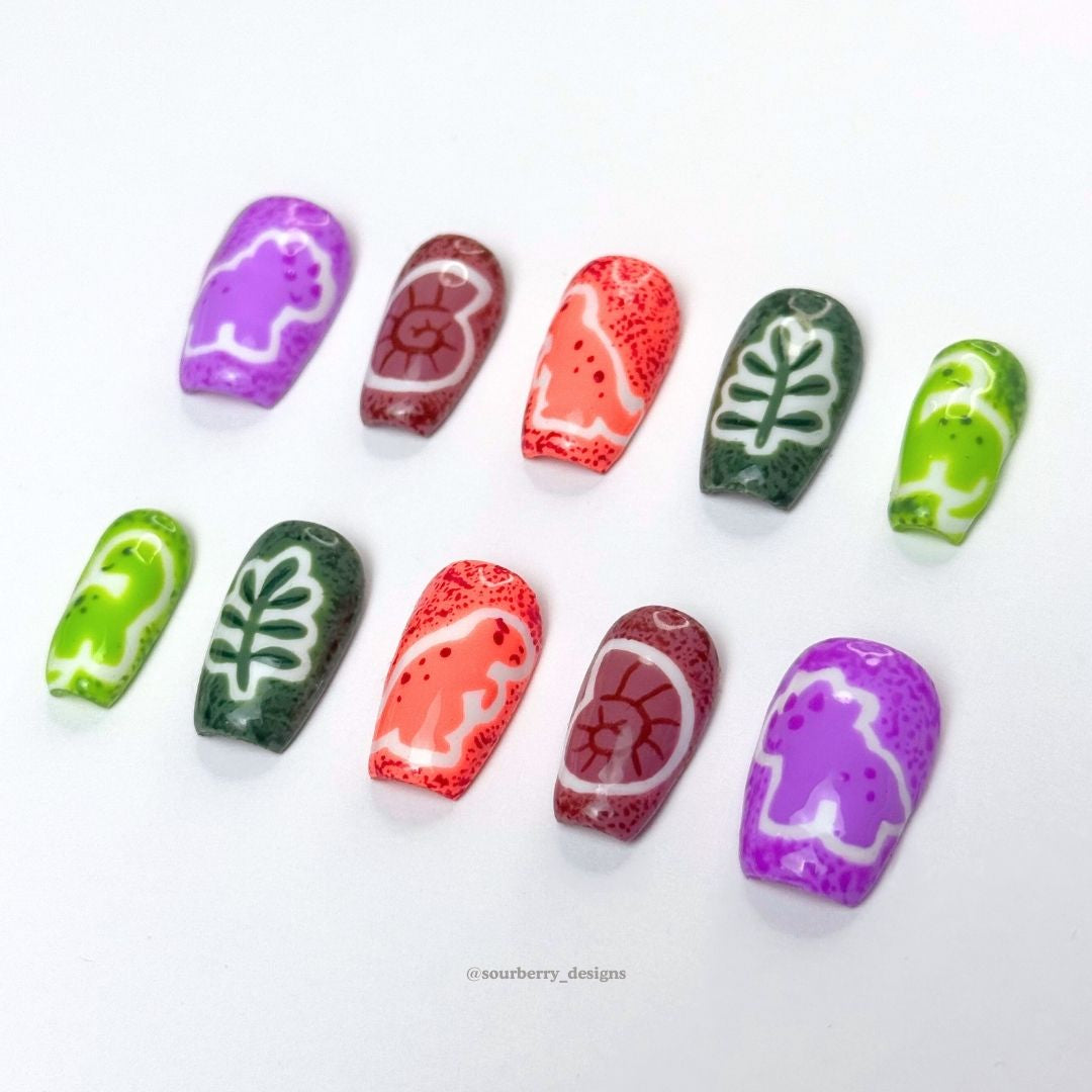 Sourberry brand tiny dinos nails at an angle.
